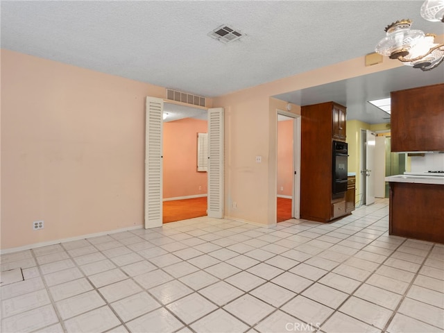 kitchen with light tile patterned flooring and a textured ceiling