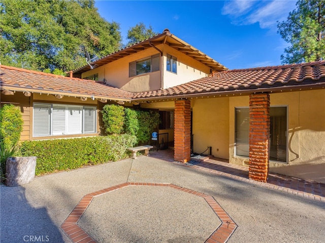 back of property with a patio