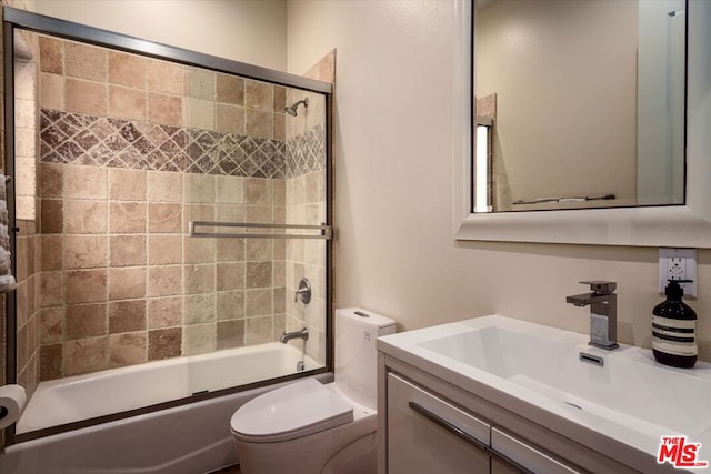 full bathroom with vanity, toilet, and enclosed tub / shower combo