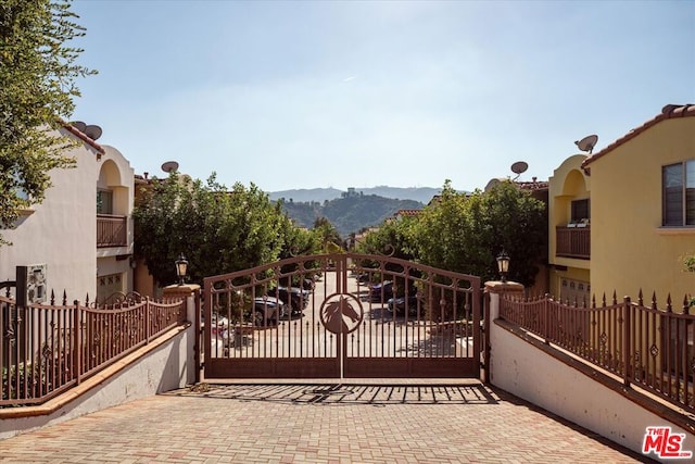 view of gate featuring a mountain view