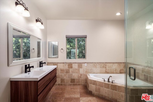 bathroom featuring vanity and shower with separate bathtub