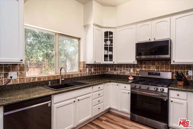 kitchen with sink, white cabinets, and appliances with stainless steel finishes