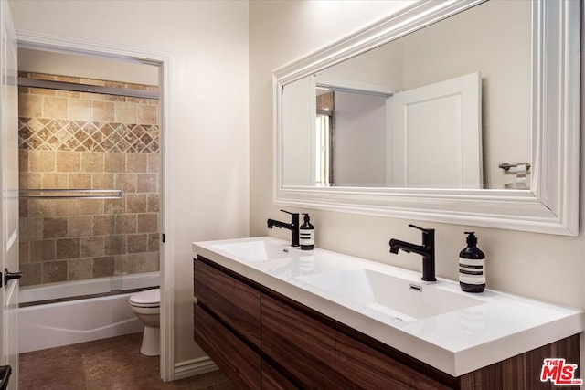 full bathroom featuring vanity, toilet, and enclosed tub / shower combo