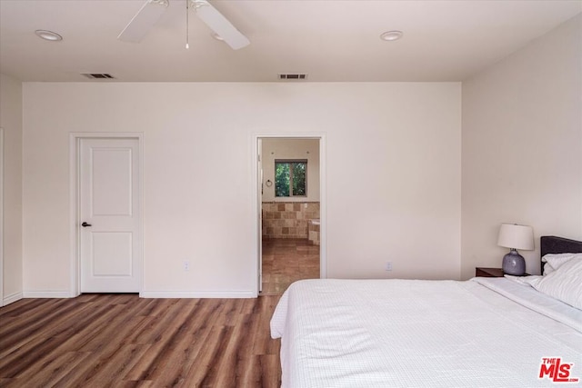 bedroom with ensuite bath, ceiling fan, and wood-type flooring