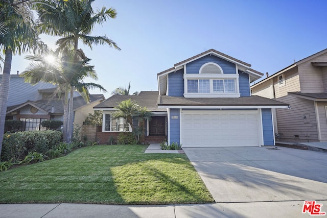 view of property with a garage and a front yard