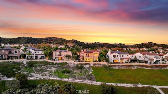 aerial view at dusk featuring a mountain view