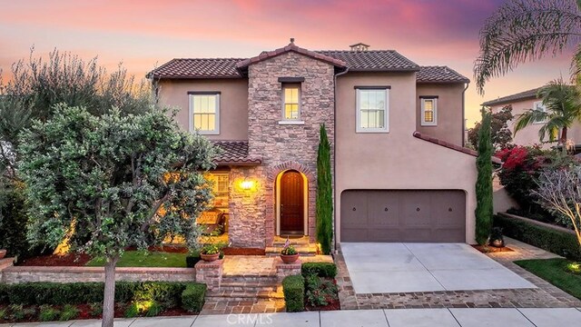 mediterranean / spanish-style house with a garage