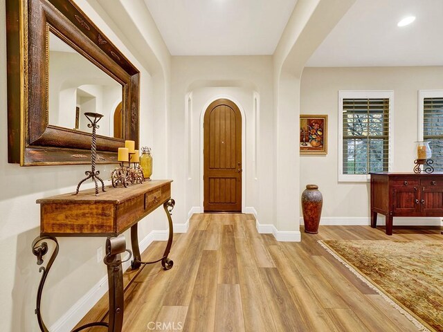 corridor with light hardwood / wood-style floors