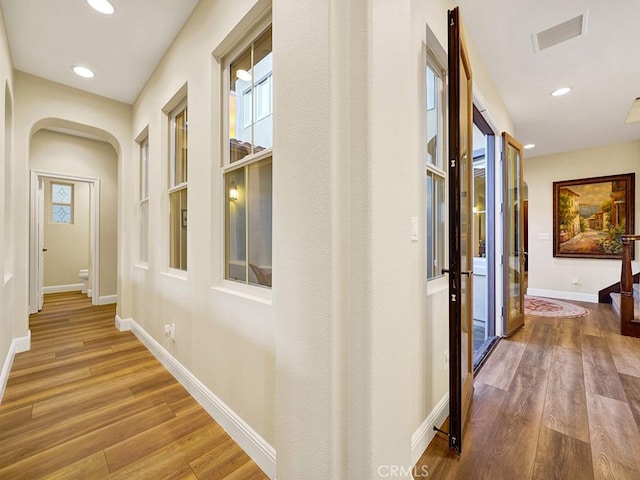 hallway with hardwood / wood-style flooring