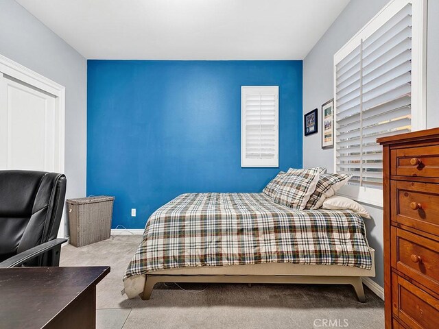 bedroom with light colored carpet