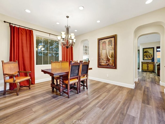 dining area with a notable chandelier and light wood-type flooring