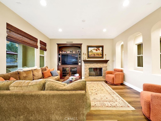 living room with hardwood / wood-style flooring and a fireplace