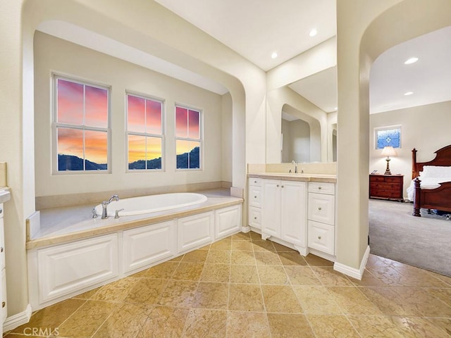 bathroom featuring vanity and a tub