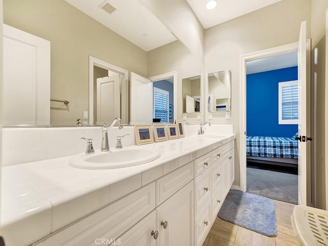 bathroom with tile patterned flooring and vanity