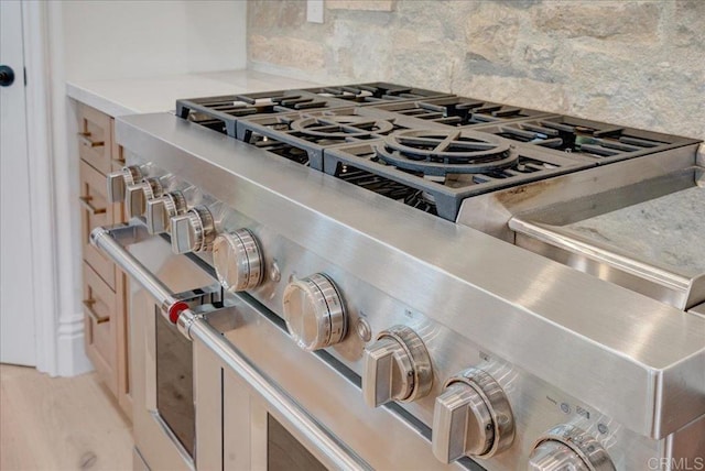 room details featuring backsplash and double oven range