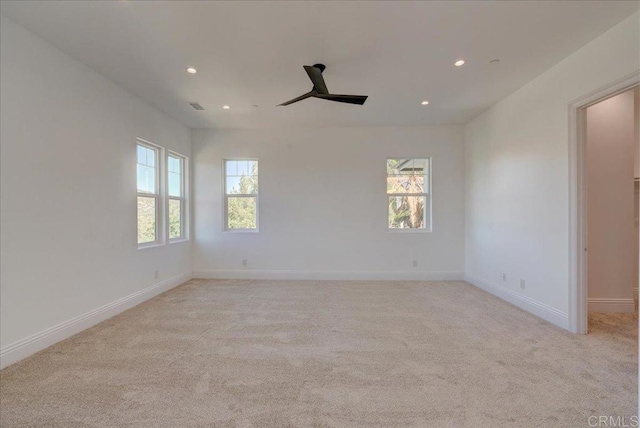 spare room with light carpet and ceiling fan