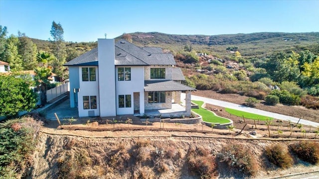 rear view of property featuring a mountain view