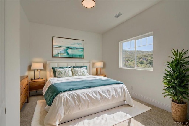 bedroom featuring light colored carpet