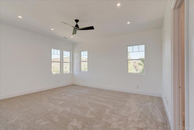 carpeted empty room featuring ceiling fan