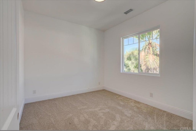 unfurnished room featuring light colored carpet