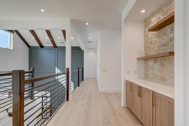 corridor featuring lofted ceiling with beams and light hardwood / wood-style flooring