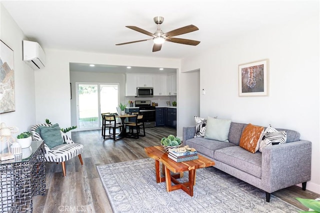 living room featuring hardwood / wood-style flooring, an AC wall unit, and ceiling fan