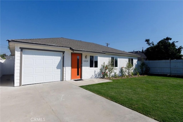 ranch-style house featuring a front yard and a garage