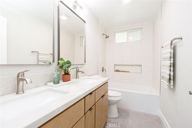 full bathroom with tile patterned floors, vanity, toilet, and tiled shower / bath