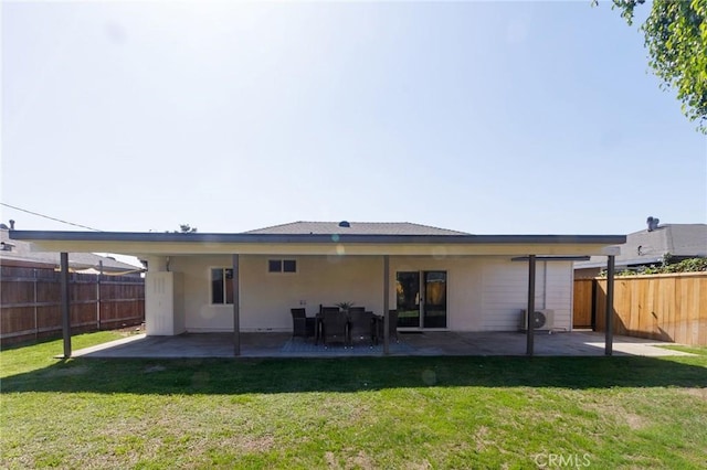 back of property with a patio area and a yard