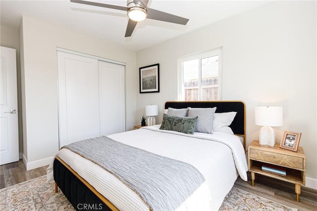 bedroom with hardwood / wood-style floors, ceiling fan, and a closet