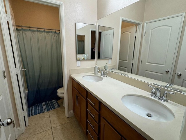 bathroom with tile patterned floors, vanity, and toilet