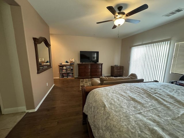 bedroom with ceiling fan and dark wood-type flooring