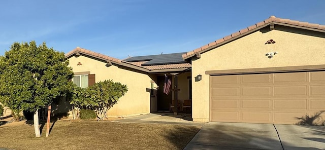 view of front of property with solar panels and a garage