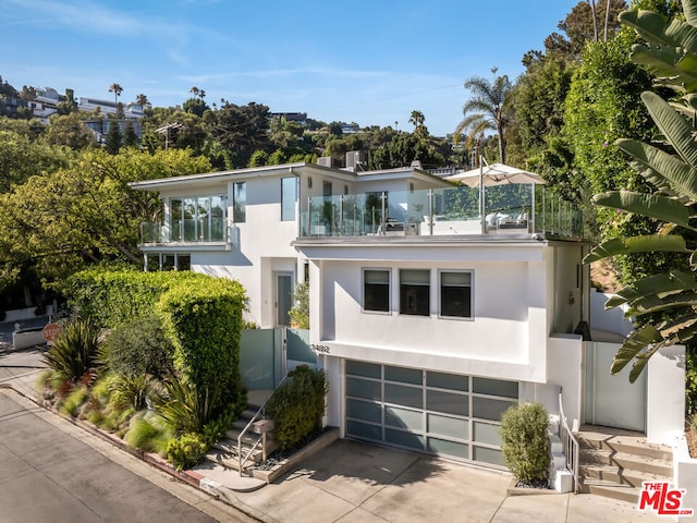 contemporary home with a garage and a balcony