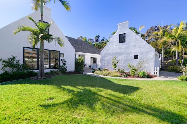 rear view of house with a yard