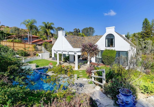 rear view of property featuring a patio and a pergola