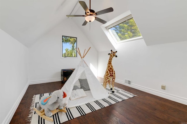 game room with lofted ceiling, dark hardwood / wood-style floors, and ceiling fan