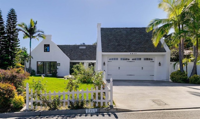 view of front facade with a garage and a front yard