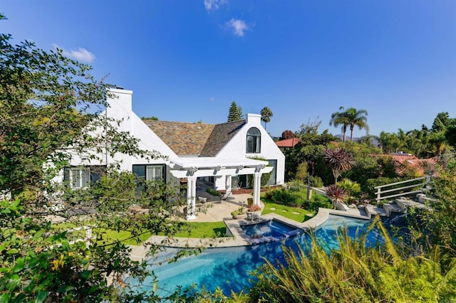 rear view of property with a pergola and a patio