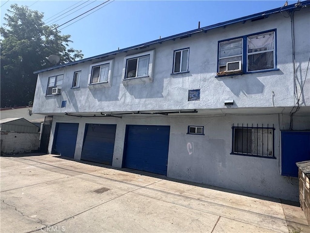 exterior space with cooling unit and a garage