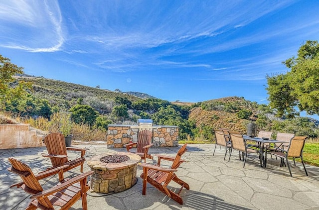 view of patio featuring a mountain view and an outdoor fire pit