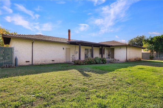 back of house with a lawn