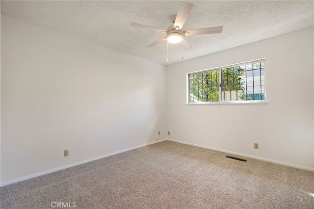 spare room with ceiling fan, carpet floors, and a textured ceiling