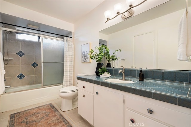 full bathroom featuring vanity, tile patterned floors, enclosed tub / shower combo, and toilet