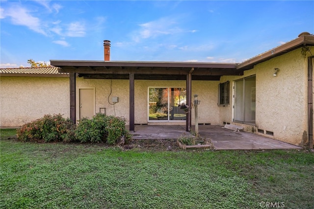 rear view of property with a patio and a yard