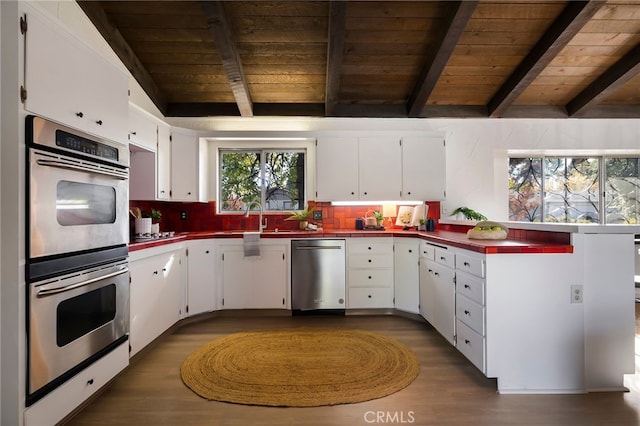 kitchen with white cabinetry, wood ceiling, and appliances with stainless steel finishes