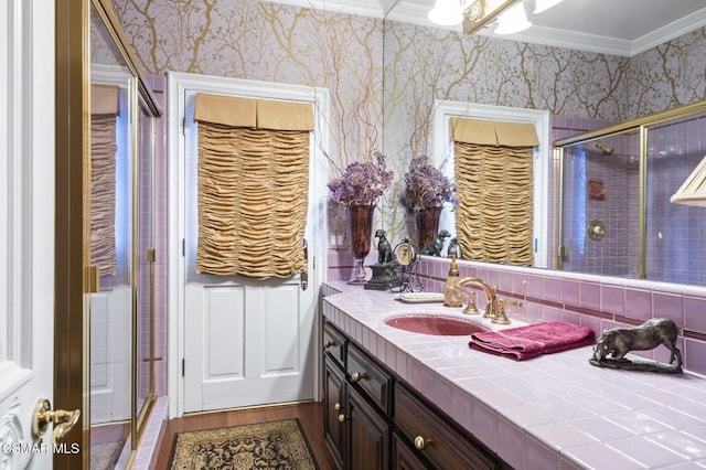 bathroom featuring crown molding, vanity, a shower with shower door, and hardwood / wood-style flooring