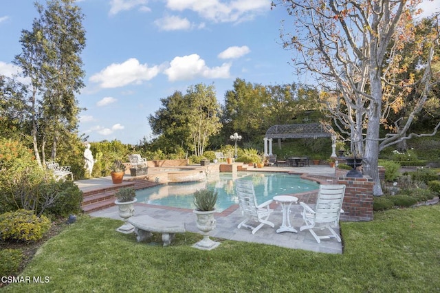 view of swimming pool with an in ground hot tub, a patio area, and a lawn