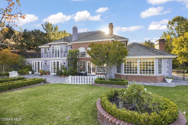 back of house featuring french doors and a yard