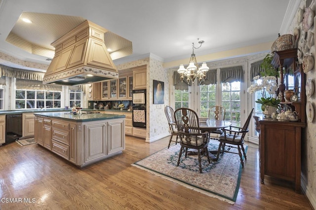 kitchen with a center island, dark hardwood / wood-style floors, an inviting chandelier, and premium range hood